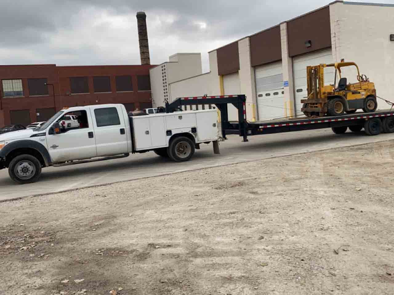 TCB Metal Works service truck hauling equipment on a gooseneck trailer