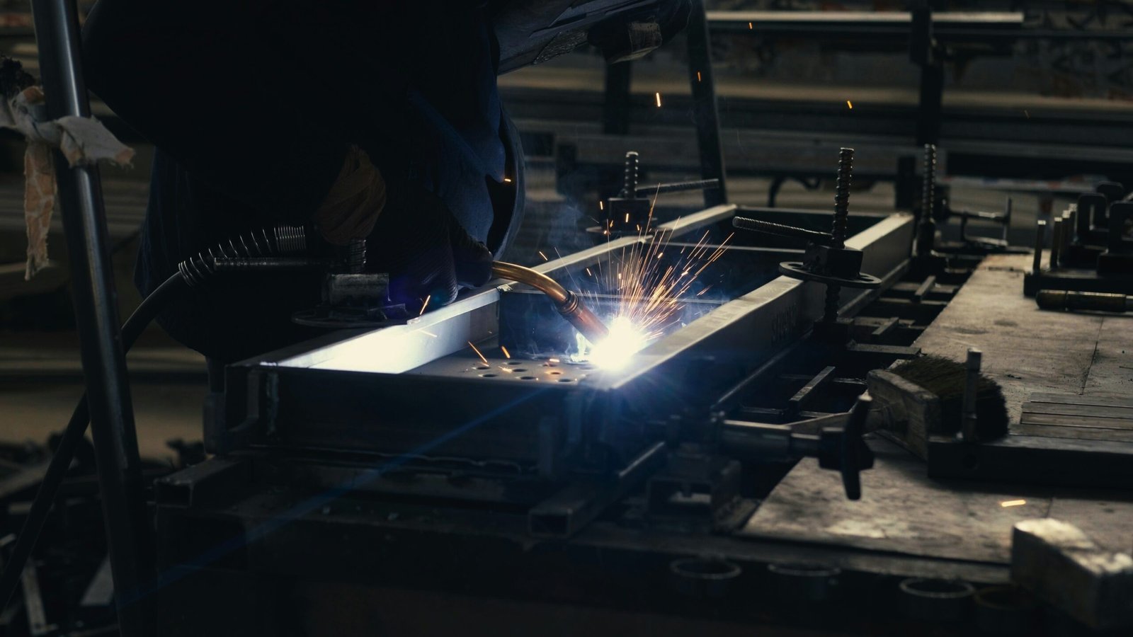 Sparks flying as a welder works molten steel in the TCB Metal Works shop