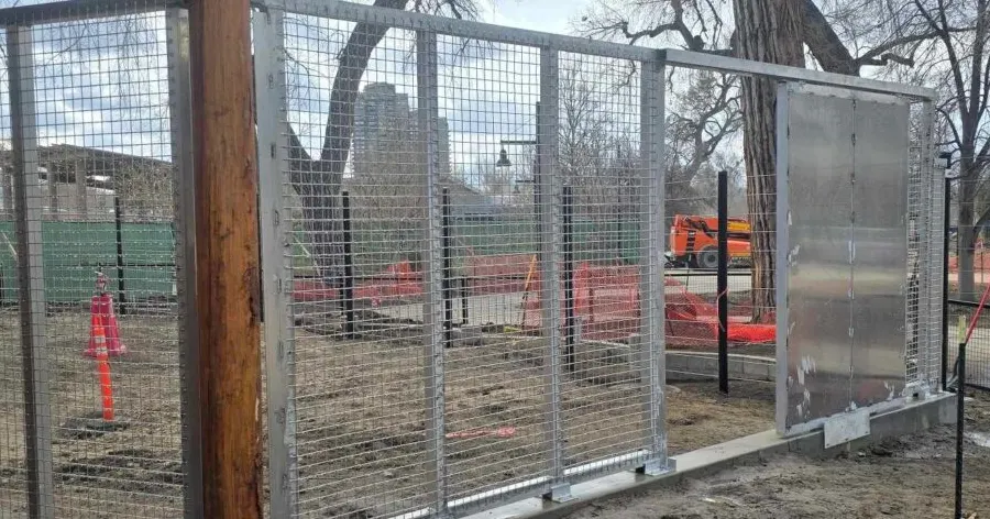 Galvanized steel framed mesh gate panels on a base track, fabricated by TCB Metal Works — the movable barriers used as shift gates between enclosure spaces