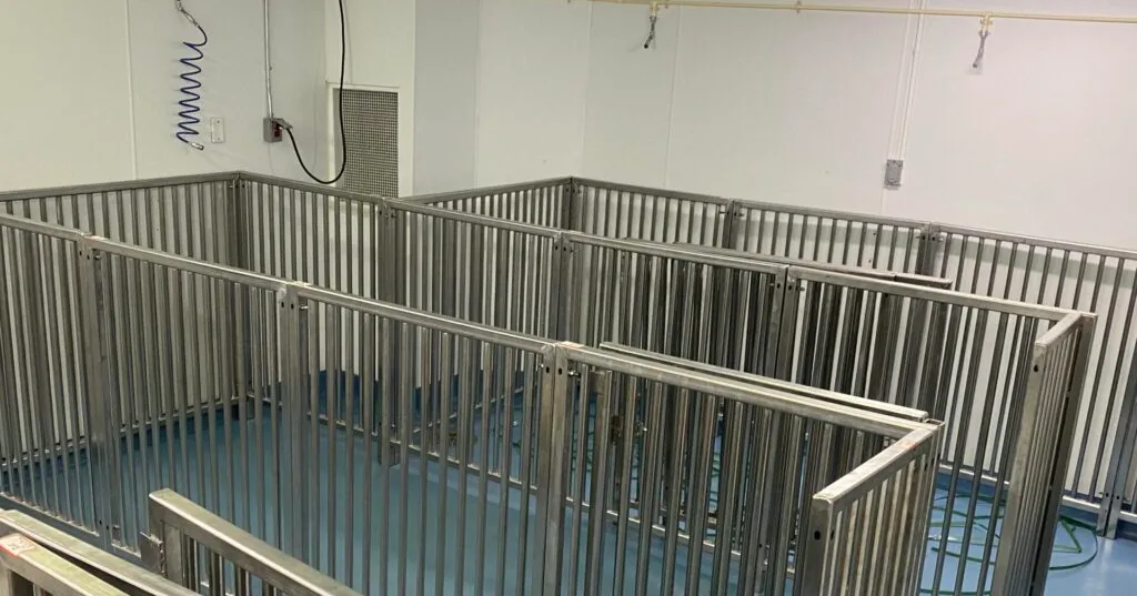 Interconnected stainless steel off-exhibit holding pens with a sealed hygienic floor, fabricated by TCB Metal Works
